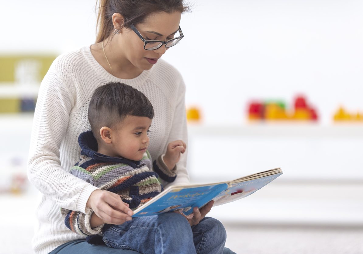 A parent sharing a picture book with a young child